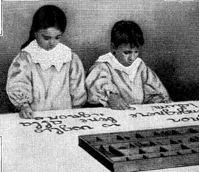 Children in a Montessori school with the movable alphabet.