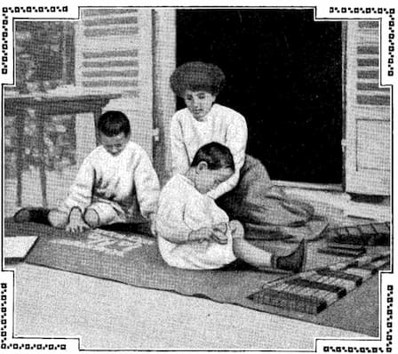 Mother working with her children in a Montessori classroom