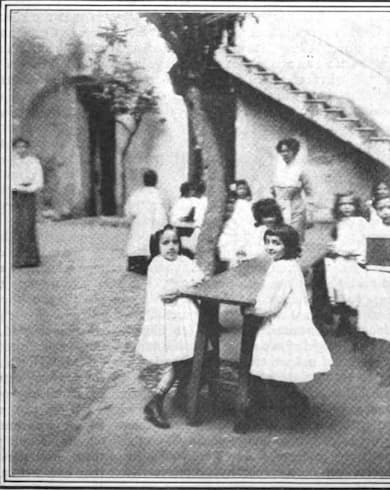 Students arranging the tables in a Montessori school