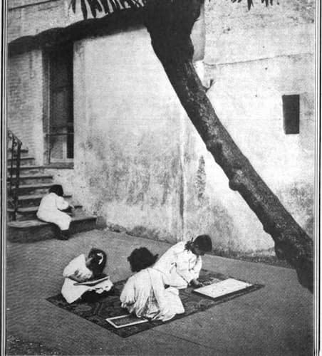 Children working on rugs in a Montessori Classroom