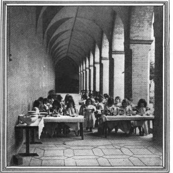 black and white photo of children eating dinner in a Montessori school