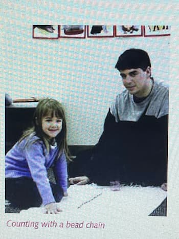 Montessori Teacher working with child with the bead frame