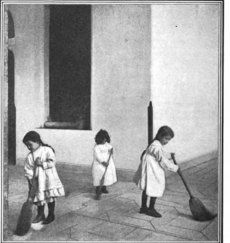 Children Sweeping the Floor in a Montessori School
